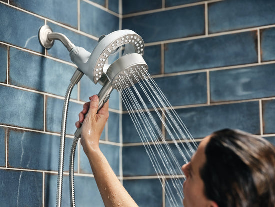 A woman using the Magnetix Plus 2-in-1 handshower.