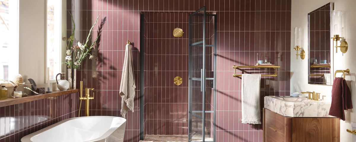 Bathroom with purple tiled walls, freestanding bathtub, and vanity area.
