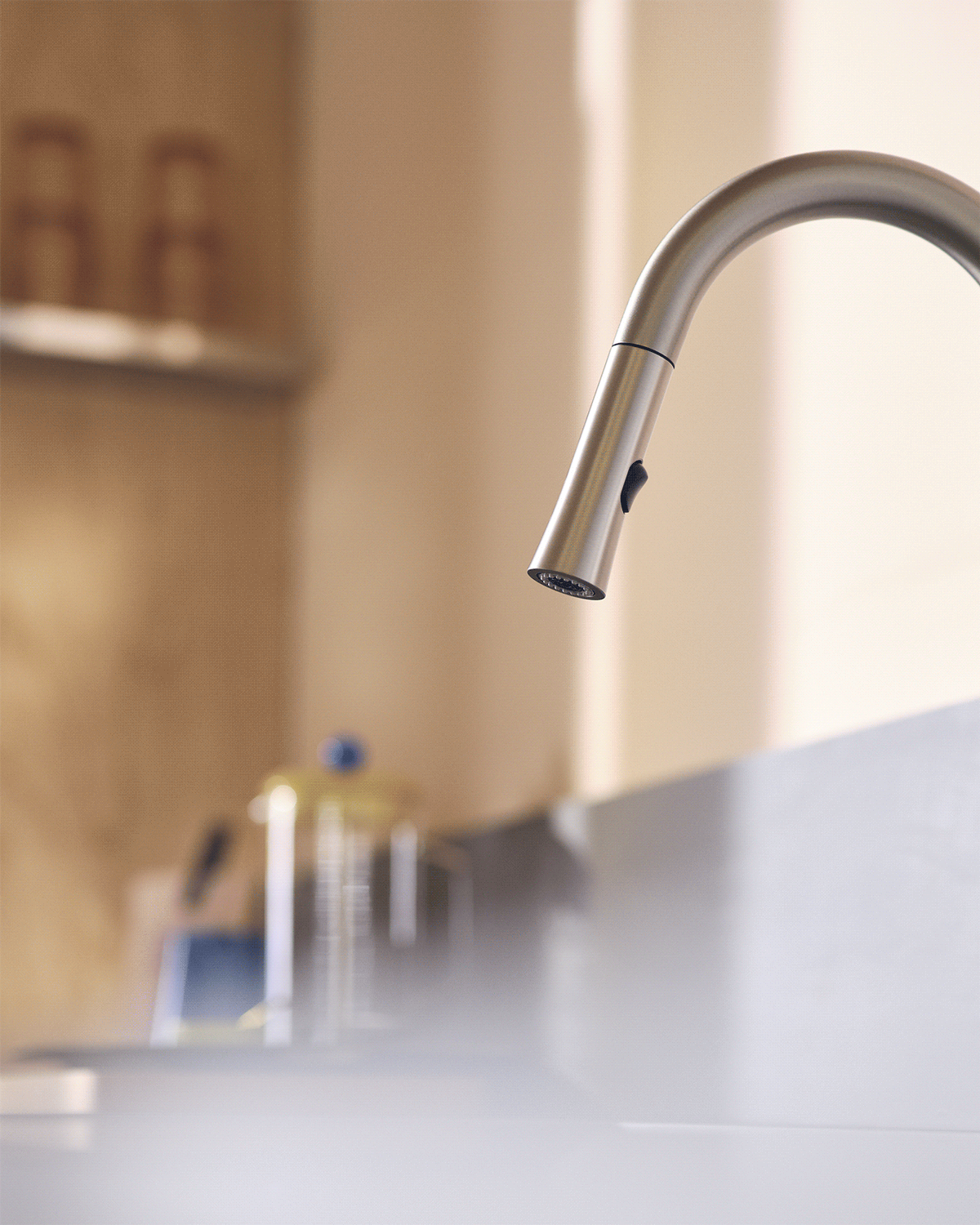 Silver Faucet moving spraying water out of flexible hose
