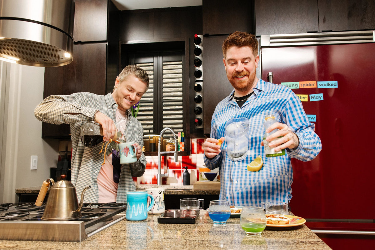 Alex and Evan pouring drinks in their kitchen