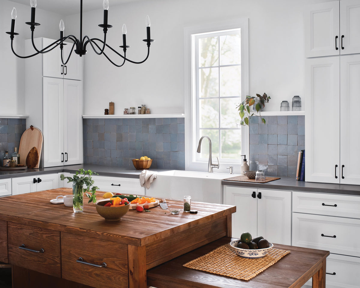 A pulldown kitchen faucet in a Heritage style traditional kitchen with a large wooden island.