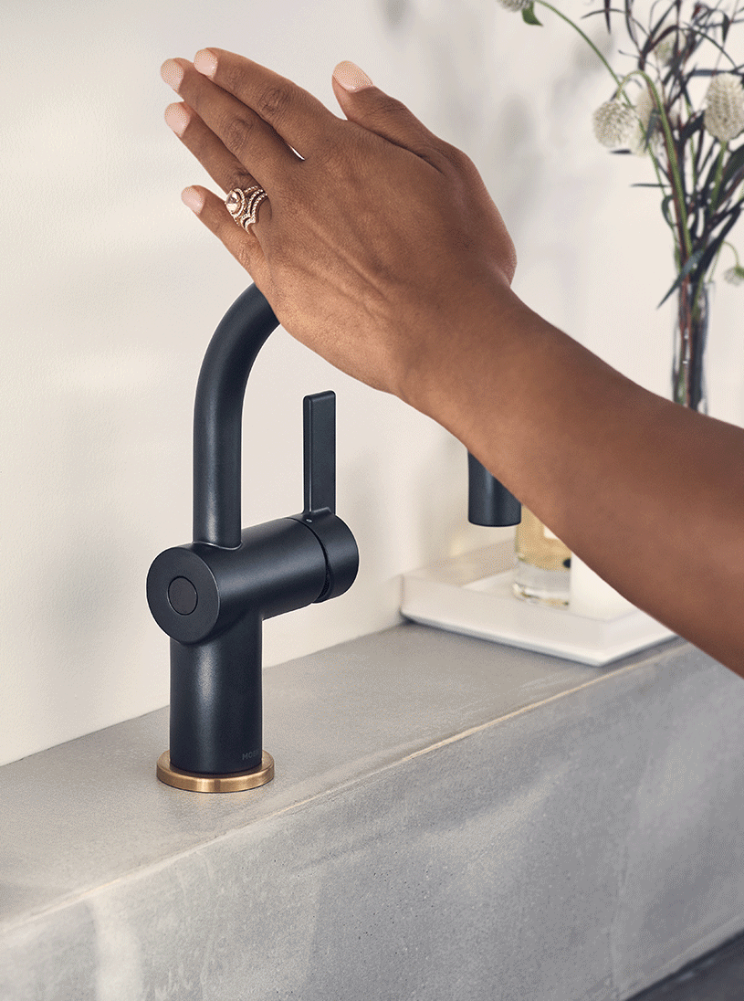 A hand waving back and forth to turn a MotionSense Wave bathroom faucet on and off.