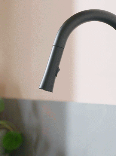 Black Faucet spraying water 