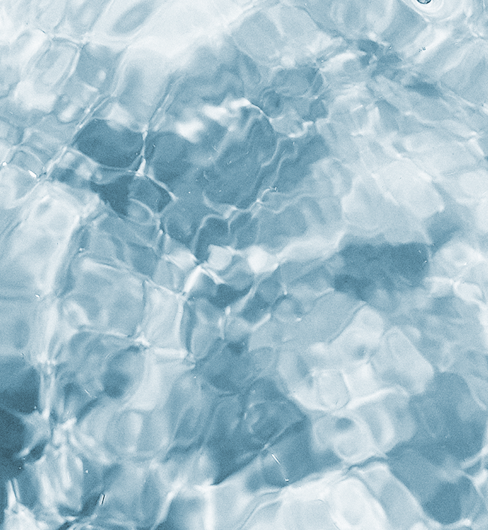 A close-up texture of clear, shallow water with light reflecting off the surface, creating a blue and white pattern.