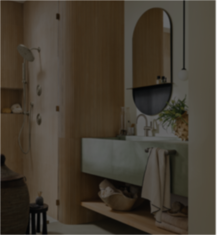 A modern bathroom interior with a light wood wall, a green floating vanity, an oval mirror, and a towel hanging over the edge. The image is noticeably dark and low-contrast.