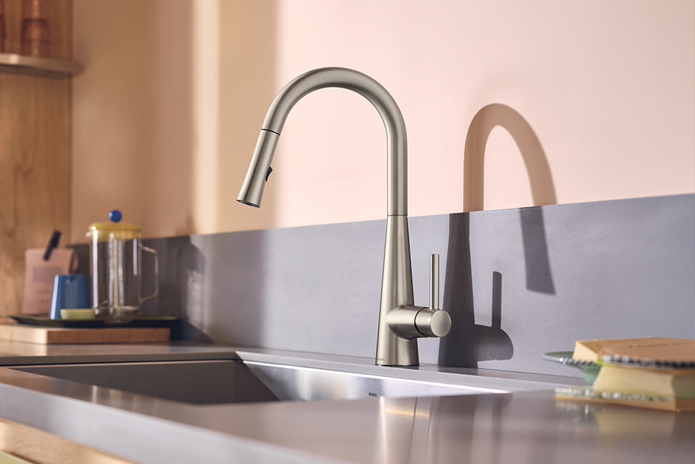 Sleek One-Handle High Arc Pulldown Kitchen Faucet, installed in a stainless steel sink with a gray backsplash.