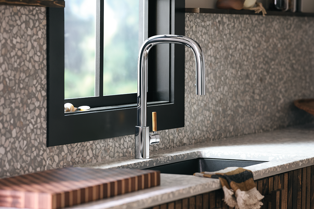 Tenon One-Handle High Arc Pulldown Bar Faucet installed above a black sink in a kitchen.