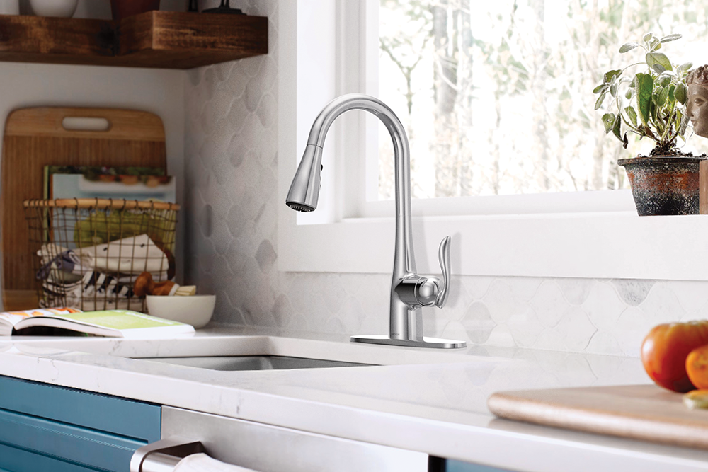 Arbor One-Handle High Arc Pulldown Kitchen Faucet, installed on a white countertop in a bright kitchen setting.