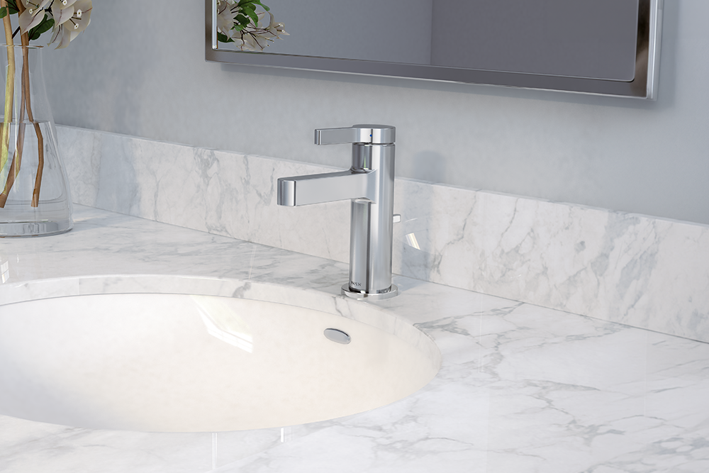 A modern chrome single-handle bathroom faucet installed on a white marble countertop with a matching marble backsplash and a white undermount sink.